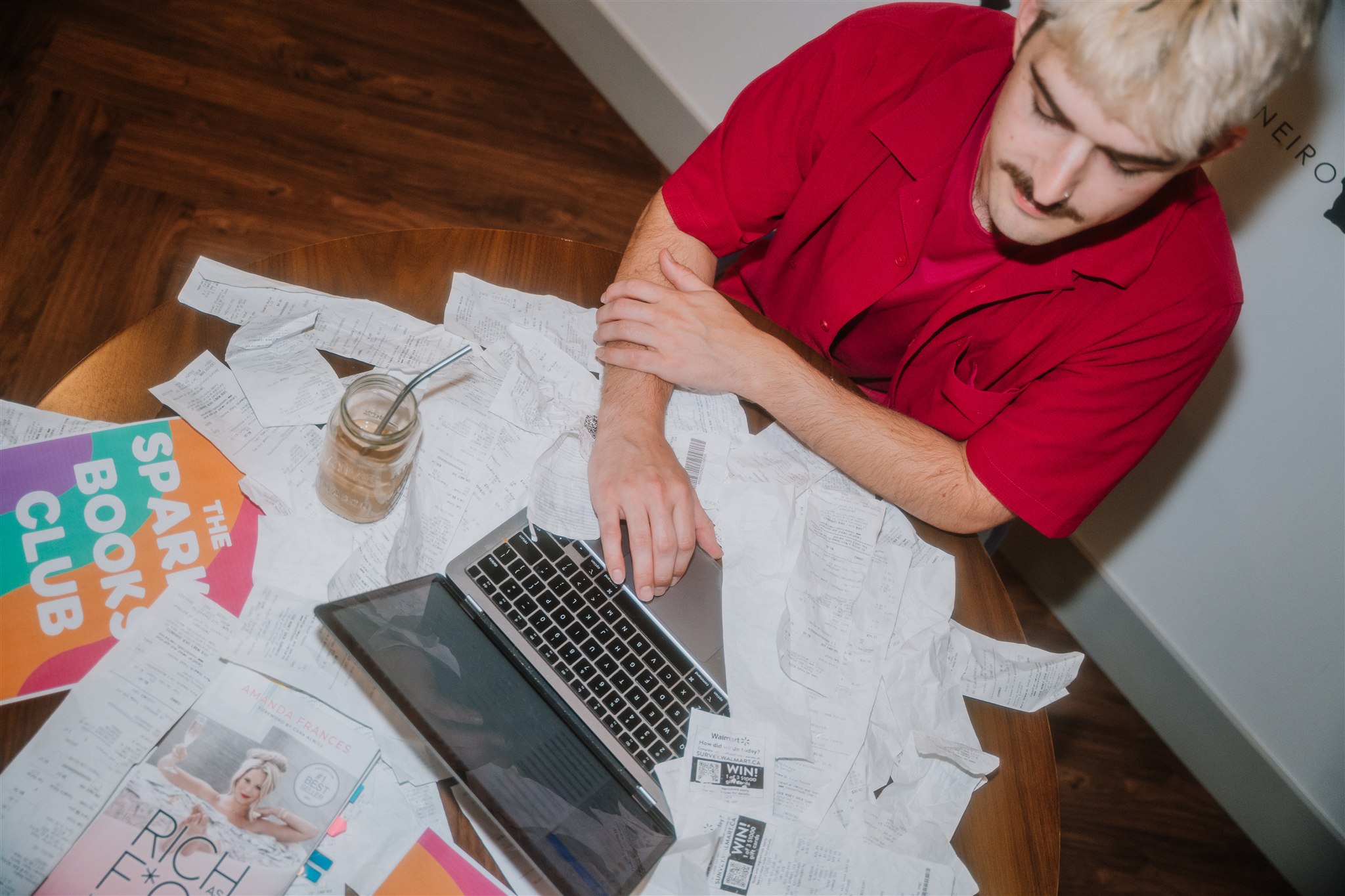 man working on a computer on a cluttered desk