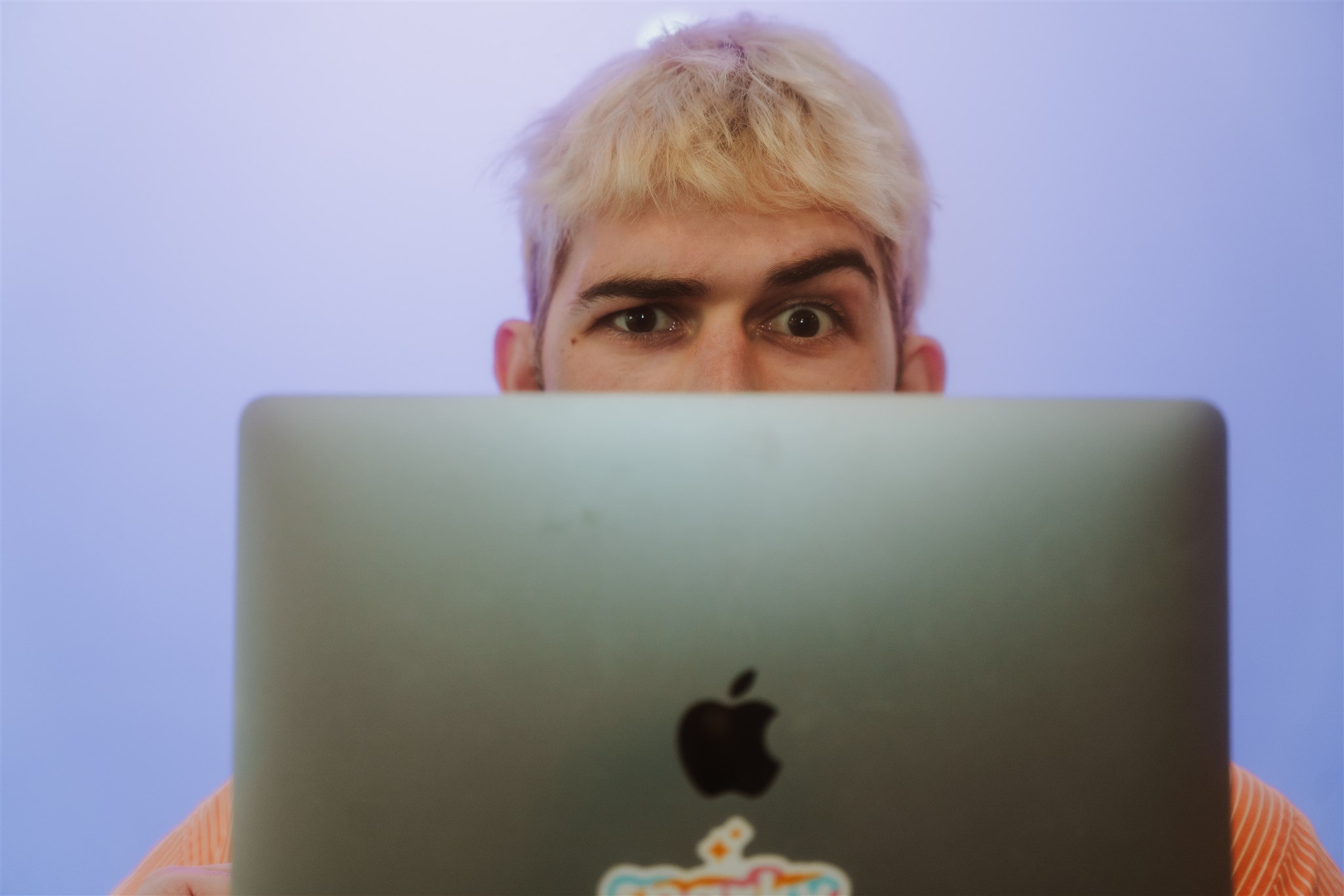 Man looking over his laptop